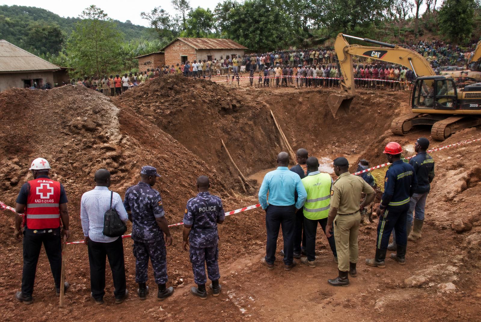 Emergency responders and police gather at a collapsed gold mining pit in Namayingo District, Uganda